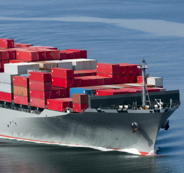 A,Container,Ship,Arriving,In,Port,On,A,Very,Calm